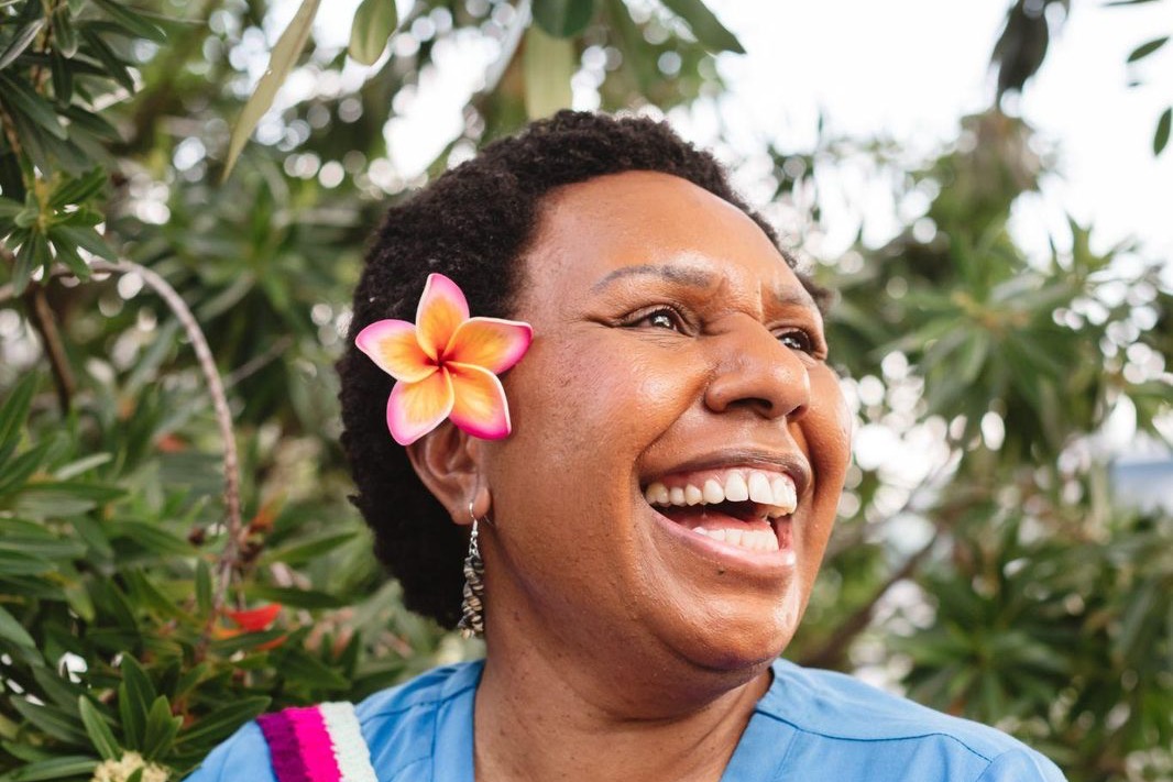 A health worker in scrubs laughing